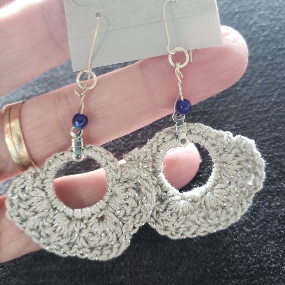 Earrings-Hand crocheted by me in silver thread with dark blue bead.